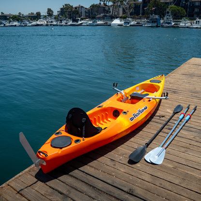 Three-quarter view of a sunset RowYak kayak with oars and paddles