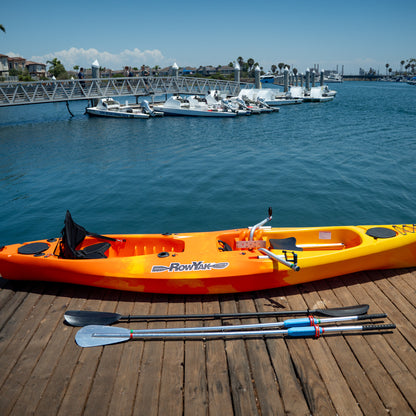 Sunset RowYak tandem kayak displayed with its oars and paddles